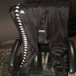 Black and white kappa track pants with zipper at ankle